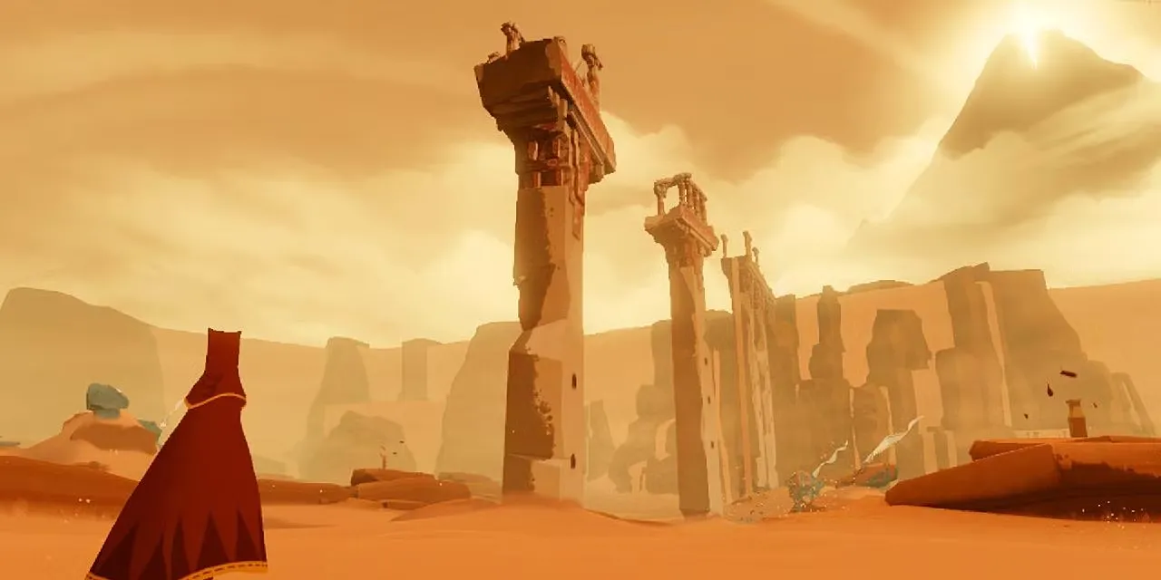 Hai nhân vật với áo choàng đỏ đang hành trình qua sa mạc rộng lớn trong game Journey