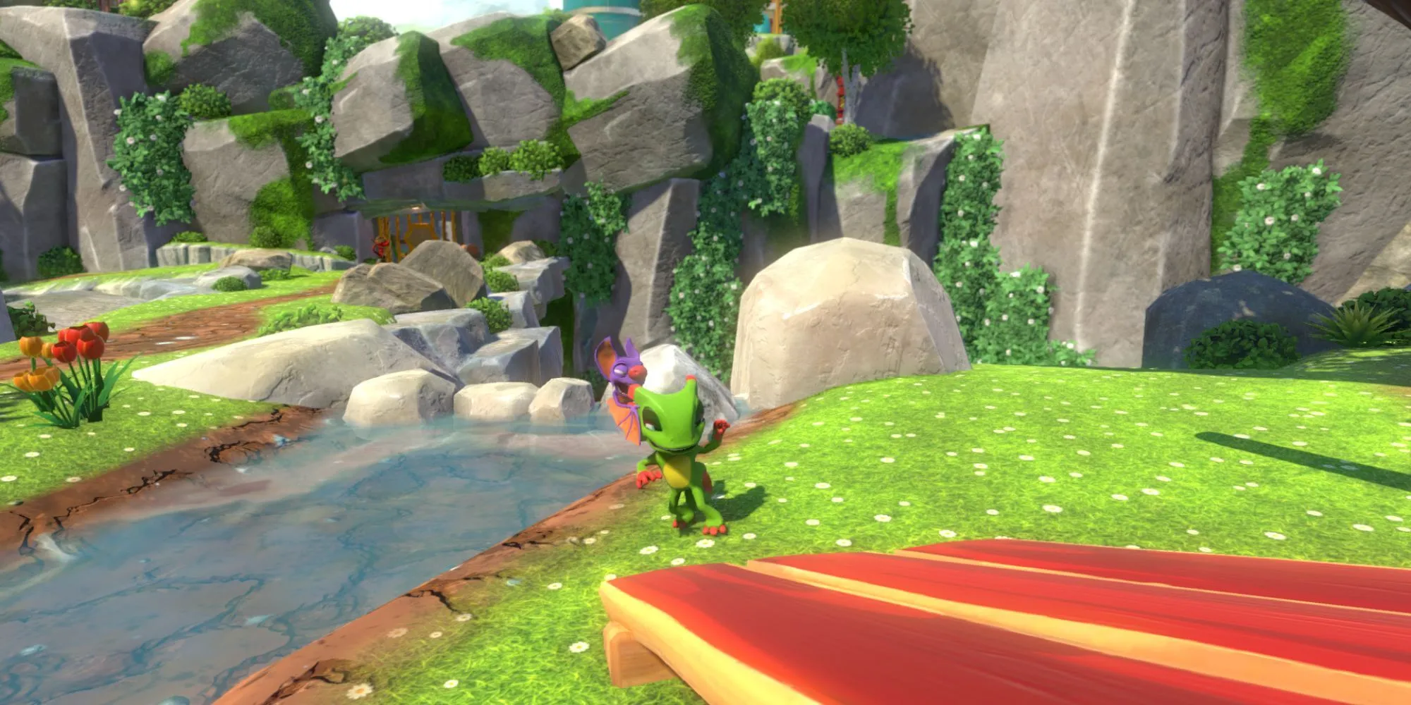 Hai nhân vật Yooka và Laylee đứng cạnh một dòng sông trong game