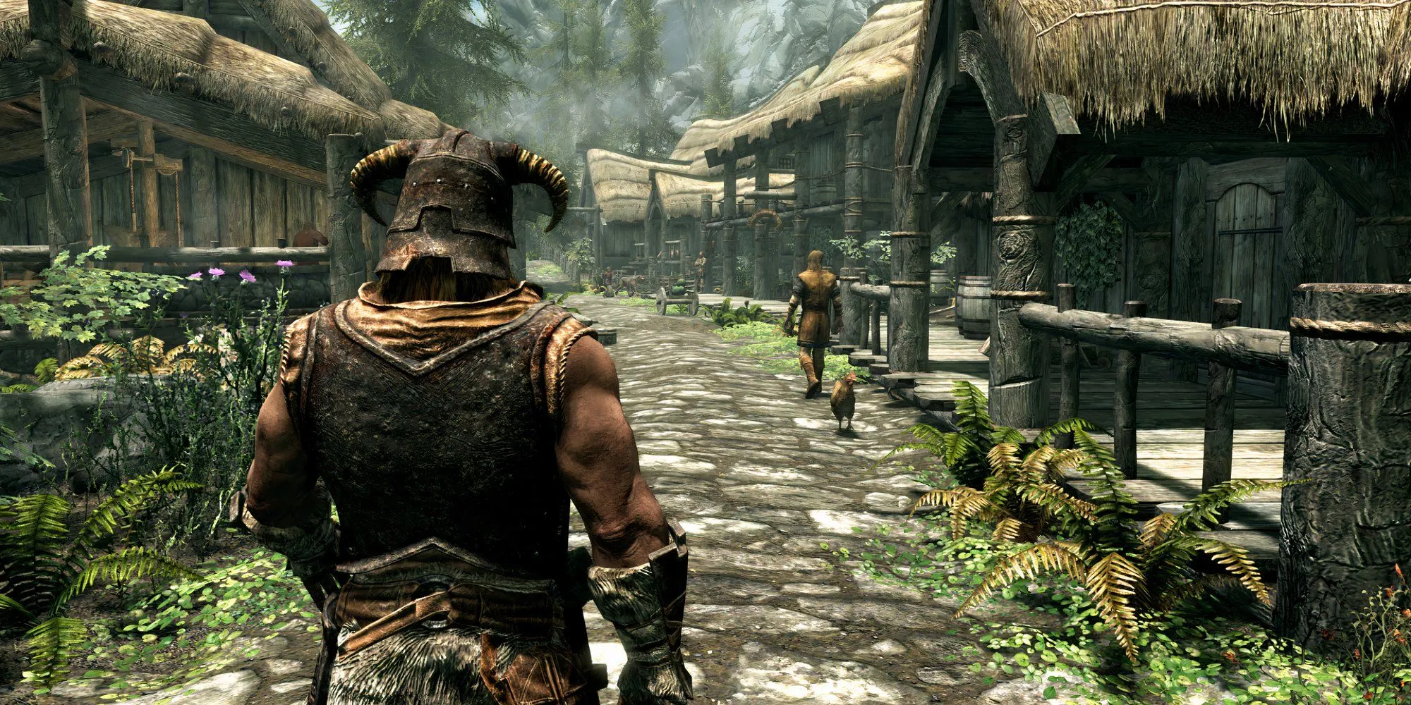 Nhân vật chính trong The Elder Scrolls V: Skyrim nhìn từ phía sau giữa khung cảnh làng mạc hùng vĩ