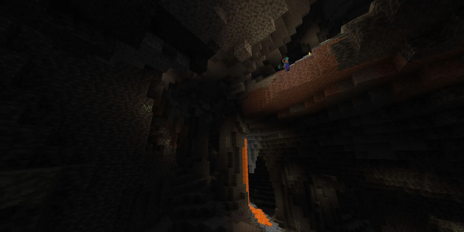 Steve cheo leo trên mép vách đá nhìn xuống một hang động khổng lồ trong Minecraft