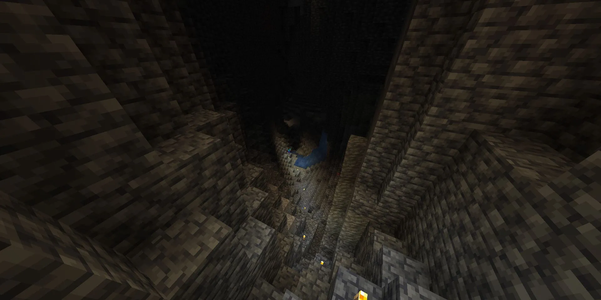 Steve thám hiểm một hang động Minecraft mới được chiếu sáng bằng đuốc